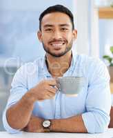 Caffeine keeps me going. a young businessman drinking a cup of coffee at work.
