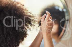 Im gonna settle down slow. Rearview shot of an unrecognizable woman looking in the mirror while applying makeup at home.