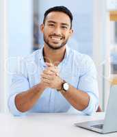 Grateful for all business opportunities. a young businessman sitting at a desk at work.