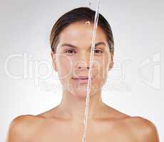 I love my skin being cleaned. a young woman getting ready to wash her face against a studio background.