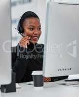 Ease your customers pain. a young woman using a headset and computer.at work in a modern office.