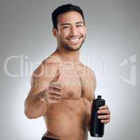 Keep up the good work and soon youll see the results. an athletic man holding a bottle of water while standing against a grey background.