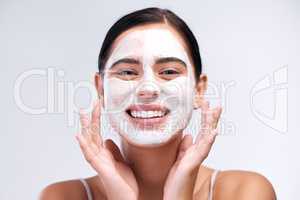Find a product thats right for your skin type. Studio shot of a young woman wearing a face mask while standing against a white background.