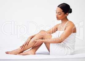 Start with loving yourself. a young woman sitting against a white background with a towel wrapped around her body.