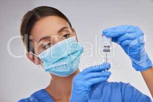 Vaccination not only saves you but others too. a nurse filling up a syringe with vaccination fluid against a studio background.