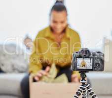 Check out what I got from this online store. a young woman recording a video for her vlog at home.