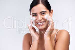 Proper skin care means cleansing it properly. Studio shot of a beautiful young woman washing her face.