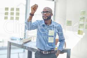 When you do what you love, youll never run out of ideas. a businessman brainstorming with sticky notes on a transparent board.