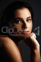 Beautiful thoughts. Studio portrait of an attractive young woman posing against a dark background.