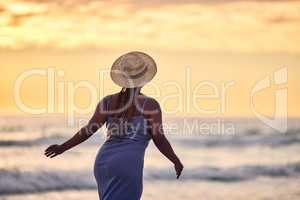 Life isnt not made for milestones, its made for moments. Rearview shot of an unrecognizable woman walking along the beach.