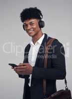 Once youve heard this track youll never look back. Studio shot of a young businessman using a smartphone and headphones against a grey background.