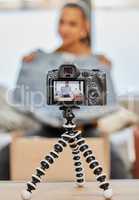 Today were talking about summer must-haves. a young woman recording a video for her vlog at home.