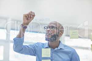 Its time for take off. a businessman brainstorming with sticky notes on a transparent board.