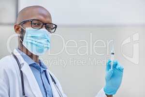 This will have you feeling better in no time. a young doctor holding a syringe filled with liquid at work.