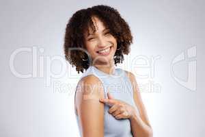 Three things in life your health, your mission, and the people you love. Studio shot of a young woman after receiving the Covid-19 vaccine against a grey background.