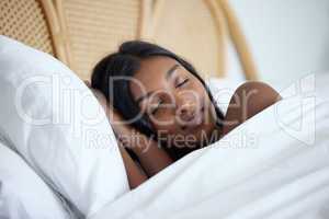 Theres nothing a good nights sleep cant fix. a beautiful young woman sleeping peacefully in her bed.
