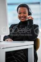Always have an attitude of gratitude. a young woman using a headset and computer.at work in a modern office.