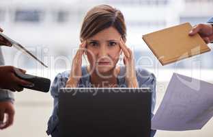 Being in charge isnt always easy. a businesswoman looking overwhelmed in a demanding office environment.