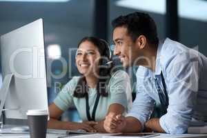 Finding ways to fix whatever concerns you. a young man and woman using a computer while working in a call centre.