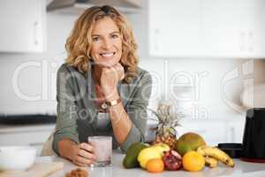 My life has never been better. a woman about to drink a glass of smoothie.