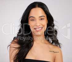 Go ahead, compliment yourself. Studio shot of a beautiful young woman posing against a grey background.