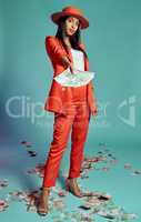 Stylish, trendy and serious woman showing or giving money while standing and posing against blue studio background. Fashionable, beautiful and serious black female giving, spending or donating money