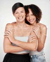 Be confident, be beautiful. Cropped portrait of two beautiful mature women posing against a grey background in studio.