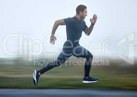 Boosting with speed in every step. a sporty young man running outdoors.