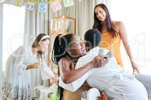 Im so thankful for you. a young mother to be hugging her friend for a gift given at her baby shower.