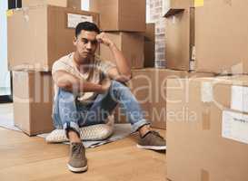 The simple lack of her is more to me. a young man being upset while sitting on the floor at home.