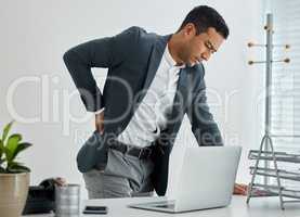 Push through the pain to get results. .shot of a businessman suffering backache in a modern office.