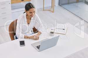 Take a seat back in your clam shell. a businesswoman on a video call in a modern office.