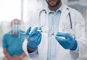 Hell have you vaccinated in no time. an unrecognizable male doctor preparing the covid 19 vaccination for a patient.