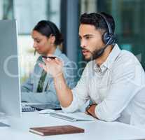 Their fast and efficient service is valued by their clients. two businesspeople working in a call center.