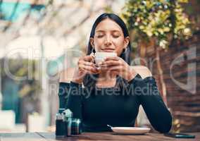 Beautiful, happy and relaxed woman smelling fresh coffee and enjoying a morning in cafe. Calm, zen and content student drinking a warm, hot and comforting cup of beverage drink in relaxing restaurant