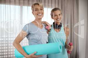 Surrounded by those who just do better. Portrait of two mature women getting ready for their workout at home.