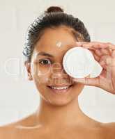 Beauty is a deeply personal journey. young woman posing with facial moisturiser at home.