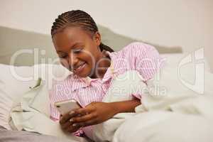 Waiting in silent glory. a young attractive woman using her cellphone.