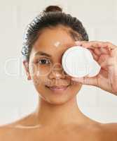 The absence of flaw in beauty is itself a flaw. young woman posing with facial moisturiser at home.