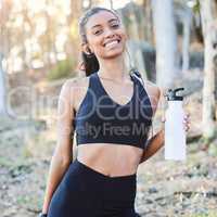 Motivation gets you started. a young woman drinking water after working out in nature.