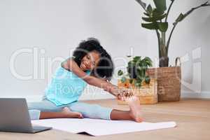 Take care of your body to take care of your mind. a young girl practicing yoga at home.