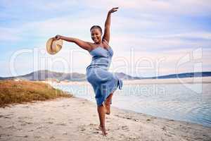 Excited to express herself through dance and movement. Feeling carefree while celebrating a beautiful seaside, beach sunset. The joy of enjoying a summer vacation and dancing in nature
