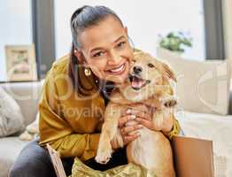 Look who found a new home. a young woman sitting at home with an adorable little dog.