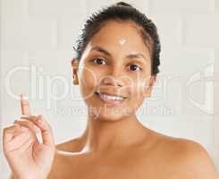 Beauty is only temporary, your mind lasts a lifetime. young woman using with facial moisturiser at home.