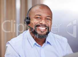 A smile can do wonders for your day. a young male call center agent at work.