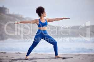 First establish peace within. a young female doing yoga on the beach.