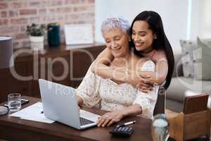 A well planned retirement ensures a sweet return. a young woman using a laptop with her elderly mother while going through finances at home.