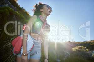 I didnt think that sunsets could get anymore beautiful. a young woman wearing her sunglasses while out on a hike.