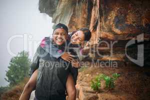 Life with you is nothing but a beautiful adventure. a young couple wearing their rain jackets while out hiking.