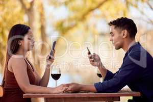 Ready for dinner with someone special. a young couple having wine on a date on a wine farm.